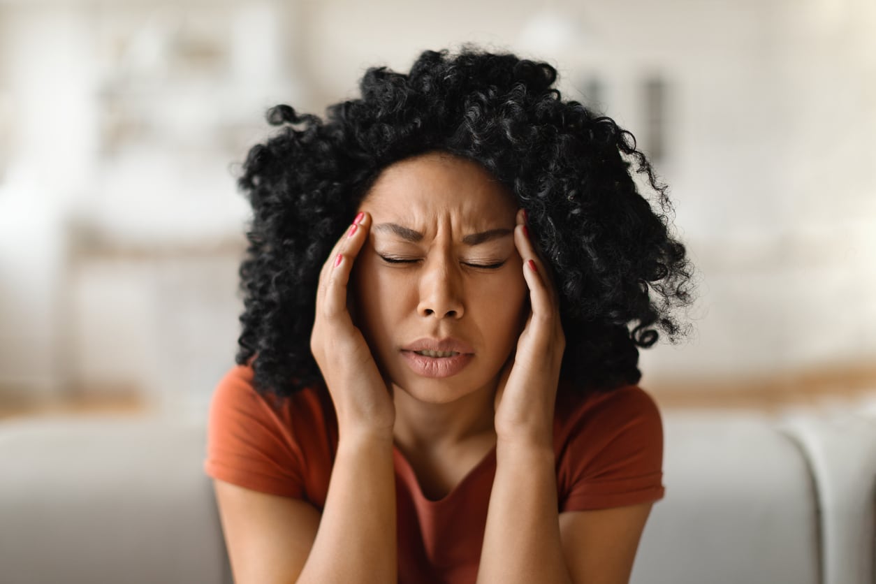 Stressed woman holding her temples